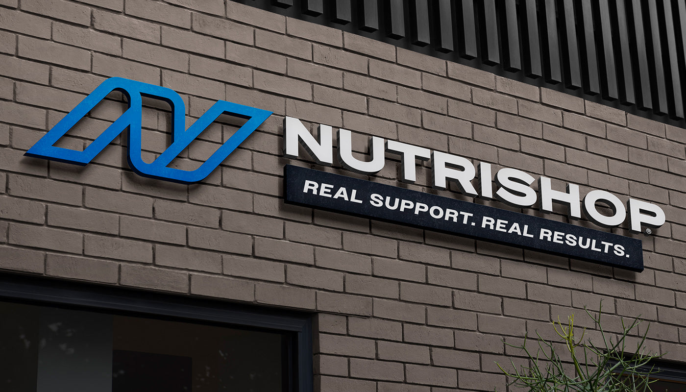 NUTRISHOP logo on a brick building with their tagline 'Real Support. Real Results'.